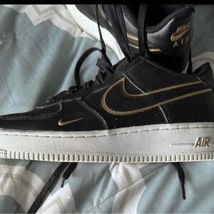Nike Black and Gold Sneakers with Classic Design